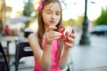 Cute school girl playing with colorful fidget spinner Royalty Free Stock Photo