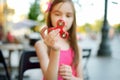 Cute school girl playing with colorful fidget spinner Royalty Free Stock Photo