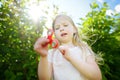 Cute school girl playing with fidget spinner on the playground. Popular stress-relieving toy for school kids and adults. Royalty Free Stock Photo