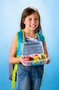Cute school girl shows her healthy lunch box Royalty Free Stock Photo