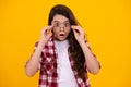 Cute school girl wearing glasses on yellow studio background, smart clever schooler girl in eyeglasses. Nerd student Royalty Free Stock Photo