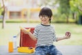 Cute schoolboy eating outdoors the school from plastick lunch boxe. Healthy school breakfast for child. Food for lunch, Lunchboxes Royalty Free Stock Photo