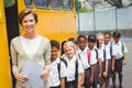 Cute schoolchildren waiting to get on school bus Royalty Free Stock Photo