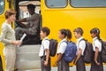 Cute schoolchildren waiting to get on school bus Royalty Free Stock Photo