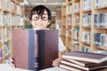 Cute schoolgirl with glasses reading books Royalty Free Stock Photo