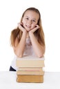 Cute schoolgirl on pile of books