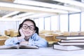 Cute schoolgirl reading books in classroom Royalty Free Stock Photo