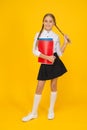 Cute schoolgirl. School education. Courses for gifted children. Basic level. Happy schoolgirl hold textbooks yellow