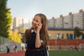 Cute schoolgirl with smartphone outdoors Royalty Free Stock Photo