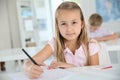 Cute schoolgirl wiritng down notes Royalty Free Stock Photo