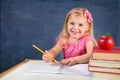 Cute schoolgirl writing on copybook