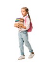 cute schoolkid holding colorful books while walking isolated on white.