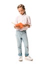 cute schoolkid holding orange book while standing on white.