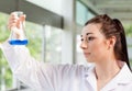 Cute science student looking at a blue liquid Royalty Free Stock Photo