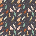 Cute seamless pattern in boho style. Colorful feathers on the dark background. Tribal feather cartoon illustration Royalty Free Stock Photo
