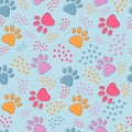 Cute seamless pattern with colorful pets paws on light blue. Cat or dog footprint outline background with dots. Animal backdrop Royalty Free Stock Photo