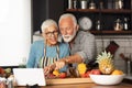 Cute senior couple preparing some healthy meal in the kitchen Royalty Free Stock Photo