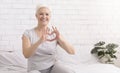 Cute senior woman making heart shape with her hands and fingers