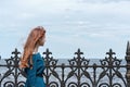 Cute serene teenager girl with red hair looking at sea and sky nature landscape, enjoying sunny weather and wind breeze outdoor on Royalty Free Stock Photo