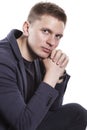 Cute serious young man in a jacket, close-up, isolated on white background Royalty Free Stock Photo