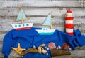 set of kids handcrafted boats, fish, nautical attributes and more on rough vintage wooden background top view Royalty Free Stock Photo