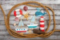 set of kids handcrafted boats, fish, nautical attributes and more on rough vintage wooden background top view