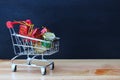 Cute shopping cart with gift boxes and mini drum