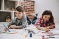 Cute Siblings Drawing Pictures Laying at Floor Royalty Free Stock Photo