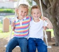 Cute siblings swinging Royalty Free Stock Photo