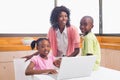 Cute siblings using laptop together with mother Royalty Free Stock Photo