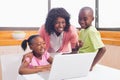 Cute siblings using laptop together with mother Royalty Free Stock Photo