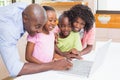 Cute siblings using laptop together with parents Royalty Free Stock Photo