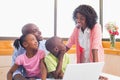 Cute siblings using laptop together with parents Royalty Free Stock Photo