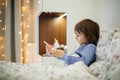 Cute sick child, boy, staying in bed, playing with teddy bear Royalty Free Stock Photo