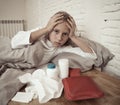 Little girl lying sick in bed feeling sick with high fever and headache having a cold flu Royalty Free Stock Photo