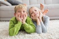 Cute silblings smiling at camera on rug Royalty Free Stock Photo