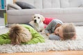 Cute silblings with their puppy on rug Royalty Free Stock Photo