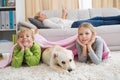 Cute silblings with their puppy on rug Royalty Free Stock Photo