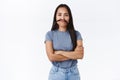 Cute silly asian girl fooling around, mimicking funny faces, cross hands over chest like boss making moustache from hair