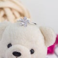 Cute silver ring in the flower shape decorated with diamonds