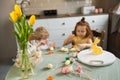 Cute sister and brother painting Easter eggs. Royalty Free Stock Photo