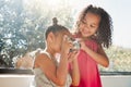 Cute sisters bonding, taking photos on camera at home, smiling while being playful and curious. Little girls playing Royalty Free Stock Photo