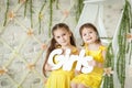 Cute little girls in spring studio