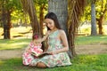 Cute sisters teen and baby girl reading book Royalty Free Stock Photo