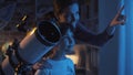 Cute sisters watching the stars with a telescope Royalty Free Stock Photo