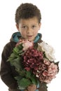 Cute six year old boy with flowers Royalty Free Stock Photo