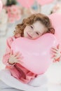 Cute six year old girl in pink dress with pink balloons in the shape of heart Royalty Free Stock Photo