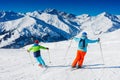 Cute skier boy with his mother having fun in a winter ski resort. Royalty Free Stock Photo