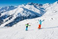 Cute skier boy with his mother having fun in a winter ski resort. Royalty Free Stock Photo