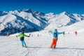 Cute skier boy with his mother having fun in a winter ski resort. Royalty Free Stock Photo